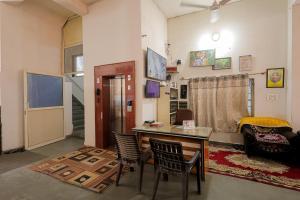 a room with a desk and chairs in a room at Omji Ashram - Ramnagar 10 min from Shri Banke Bihari Temple in Vrindāvan