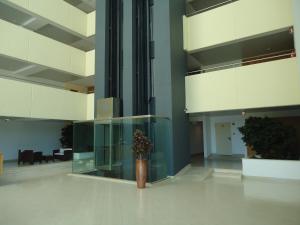 a lobby with a vase with a plant in it at Marina Vilamoura Apartment in Vilamoura