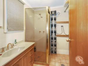 a bathroom with a shower and a sink at Alpine Digs in Jindabyne