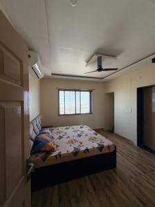 a bedroom with a bed and a ceiling fan at cloud nine in Boria Kalān