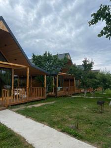 a house with a gambrel roof and a yard at Silence Houses in Tossor