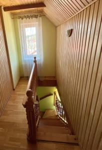 a spiral staircase in a house with a window at Passage Apartments 10a in Skhidnitsa