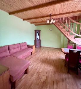 a living room with a couch and a wooden floor at Passage Apartments 10a in Skhidnitsa