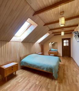 a bedroom with a bed and a skylight at Passage Apartments 10a in Skhidnitsa