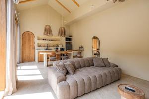 a living room with a couch and a table at 1 BR Private Pool Villa for Two - Casa Manja in Krambitan