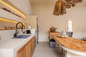 a kitchen with a sink and a wooden counter top at 1 BR Private Pool Villa for Two - Casa Manja in Krambitan +39 photos
