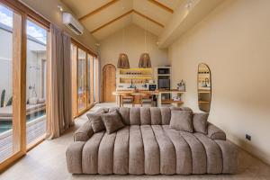 a living room with a large couch in a room at 1 BR Private Pool Villa for Two - Casa Manja in Krambitan