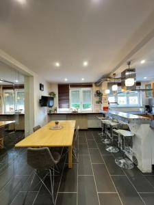 a large kitchen with a wooden table and chairs at L'Escapade Sélestadienne in Sélestat