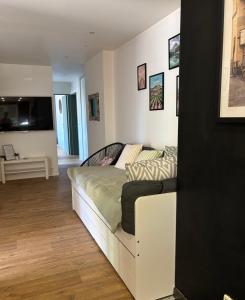 a bedroom with a bed and a living room at L'Escapade Sélestadienne in Sélestat