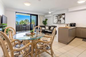 a kitchen and living room with a table and chairs at Sea Air 2 in Yeppoon