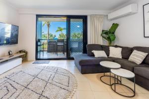 a living room with a couch and a table at Sea Air 2 in Yeppoon