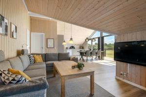 a living room with a couch and a table at C11326-Tarm-Sortbaervej-20 in Tarm