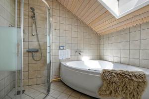 a bathroom with a bath tub and a shower at C11326-Tarm-Sortbaervej-20 in Tarm +29 photos