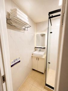 a small bathroom with a sink and a mirror at Margad Hotel in Ulaanbaatar