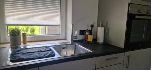 a kitchen counter with a sink and a window at Ferienhaus Alex in Gönnersdorf +31 photos