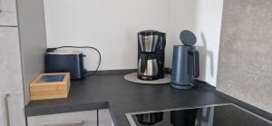 a kitchen counter with a blender on top of it at Ferienhaus Alex in Gönnersdorf
