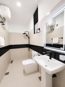 a white bathroom with a sink and a toilet at Villa 777 in Kadawata +39 photos