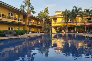 a swimming pool in front of a hotel at Bacchus Home Resort Pranburi in Ban Pak Nam Pran