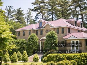 a large house with a pink roof at FOREAT akemanomori in Daisen