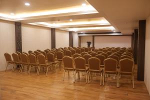 a room with a bunch of chairs and a podium at The Hotel Chettungal in Angamaly