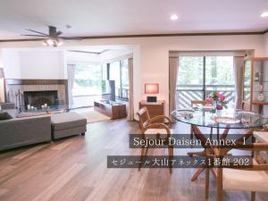 a living room with a couch and a table at FOREAT akemanomori in Daisen