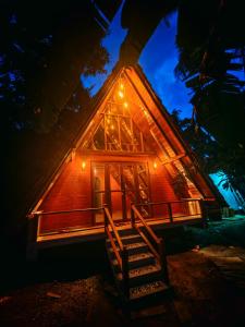 a cabin at night with lights on the front at Paddy field Whispering wind Cabin in Ahangama Nakanda