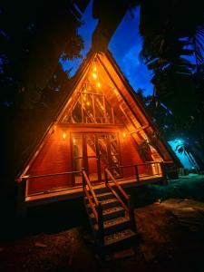 a house with a staircase leading to it at night at Paddy field Whispering wind Cabin in Ahangama Nakanda