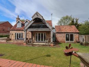 a brick house with a roof at Redwoods in Beverley