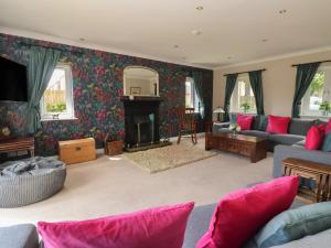 a living room with a couch and a fireplace at Redwoods in Beverley