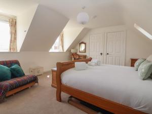 a bedroom with a bed and a chair in it at Redwoods in Beverley