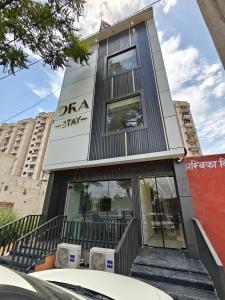 a building with a sign on the side of it at Ora Stay in Pānīpat