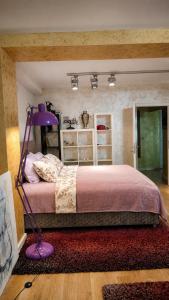a bedroom with a purple bed and a purple lamp at Rezevici AZUR in Budva