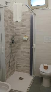 a bathroom with a shower and a toilet at Locri27 Apartment in Catanzaro Lido +14 photos