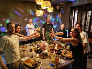 a group of people standing around a table with drinks at Hostal Central Oaxaca in Oaxaca City