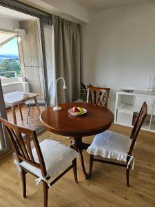 a dining room table and chairs with a bowl of fruit on it at Apartment 416 mit Pool in Lahnstein