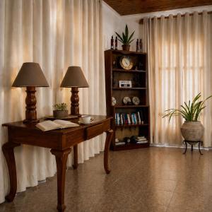 a room with a table and two lamps and a book shelf at Toiwo Residence 4BR Home in Ilboru, Arusha in Arusha