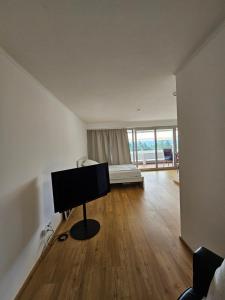 a living room with a flat screen tv on a table at Apartment 416 mit Pool in Lahnstein