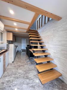 a wooden staircase in a room with a kitchen at Sun House Luka in Radmirje