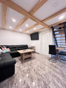 a living room with a couch and a table at Sun House Luka in Radmirje