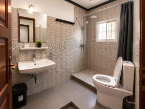 a bathroom with a toilet and a sink at KFC Homes in Yaoundé