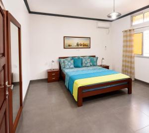 a bedroom with a bed in a white room at KFC Homes in Yaoundé
