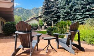 two chairs and a bench sitting on a patio at Sun Valley Adventures Heated Pool & Spa in Ketchum