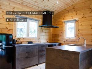 a kitchen with wooden walls and a counter top at FOREAT akemanomori in Daisen +50 photos