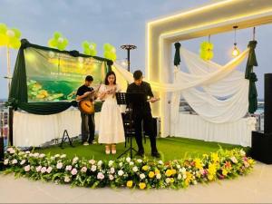 a man and a woman standing on a stage with a guitar at Khemra Kampot Hotel in Kampot in Kampot