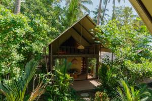 a small house in the middle of the forest at Vela Tianyar Boutique Resort - Oceanfront in Tianyar