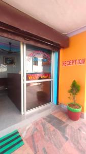 a window of a restaurant with a tree in front of it at Hotel Park Royal in Pithorāgarh