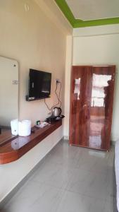a room with a counter with a tv on the wall at Hotel Park Royal in Pithorāgarh +8 photos