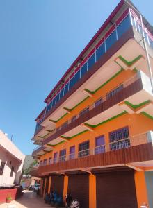 a colorful building with a balcony on a street at Hotel Park Royal in Pithorāgarh