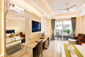 a hotel room with a bed and a desk at Arista Haven Hotel in Rishīkesh