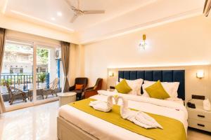 a bedroom with a large bed with towels on it at Arista Haven Hotel in Rishīkesh +18 photos